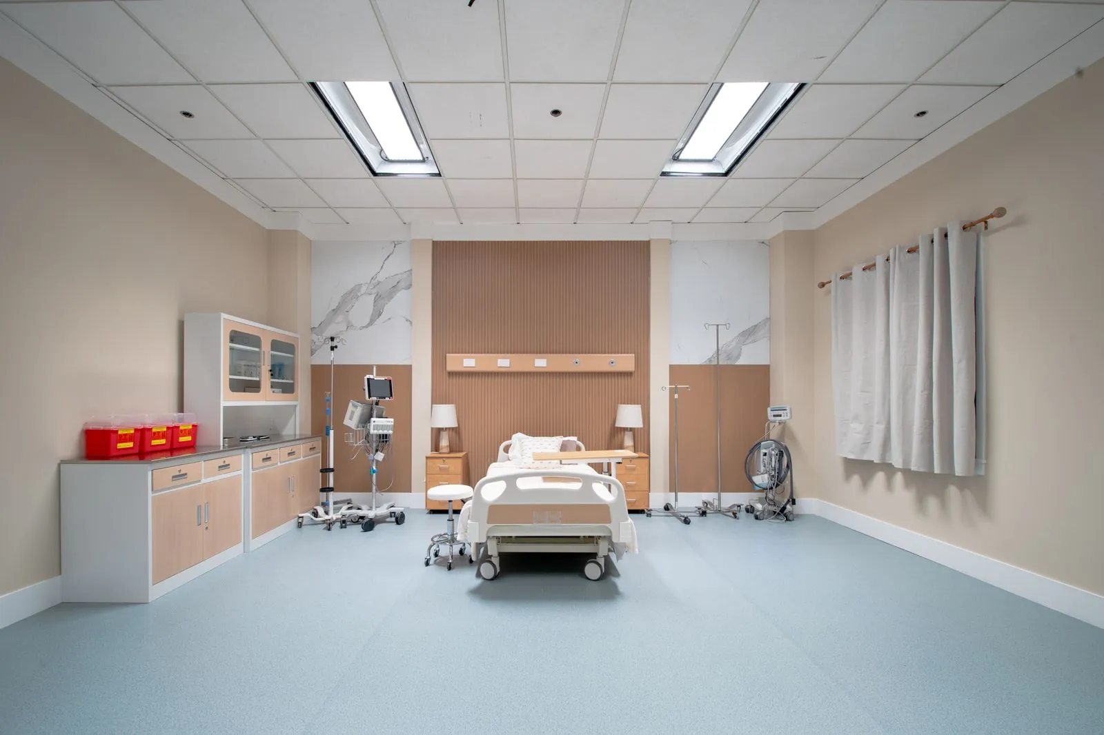 Private patient room with bed, headwall and window backing