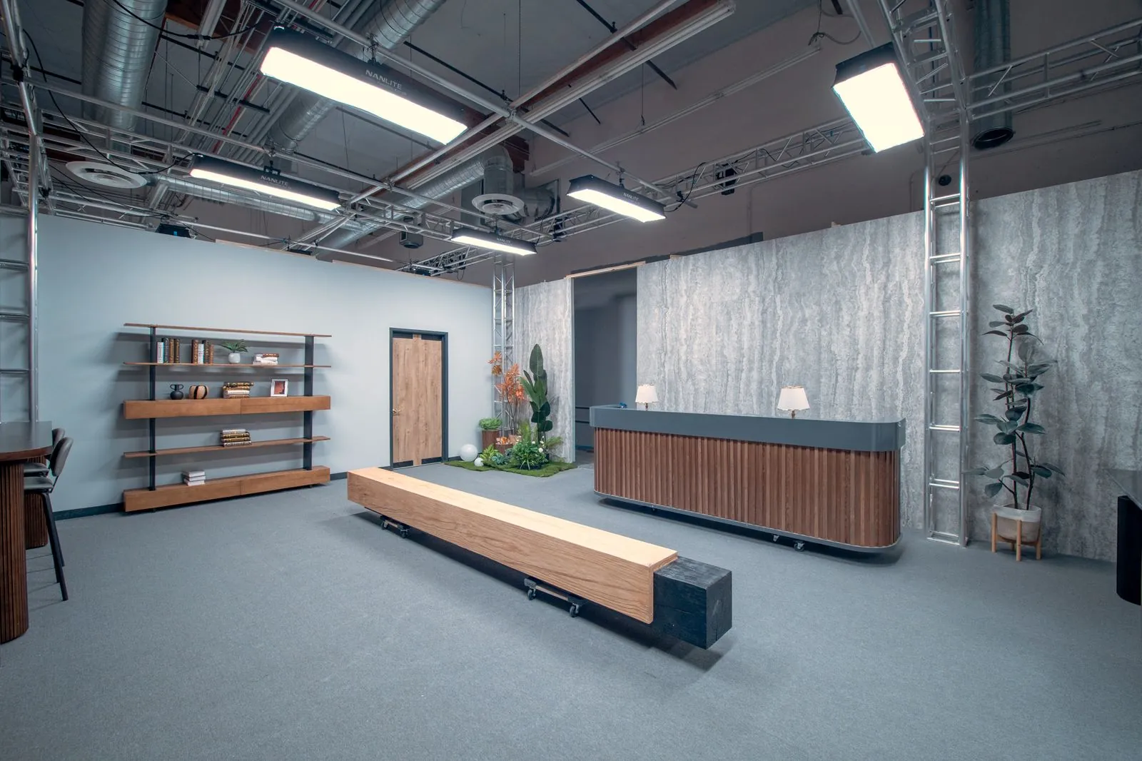 Lobby of the office set, with open shelving, reception desk and wood bench