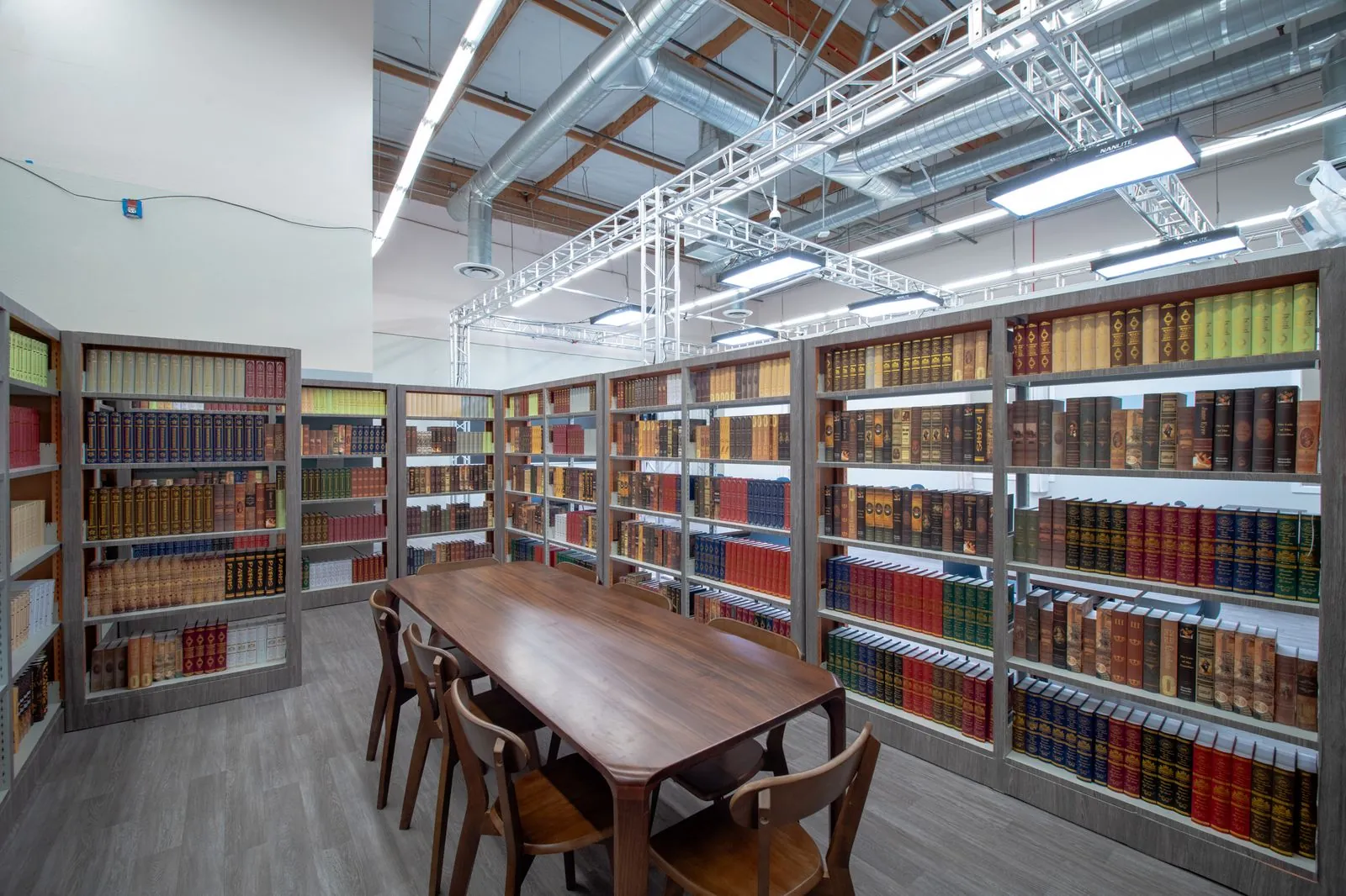 School library with full stacks and a reading table