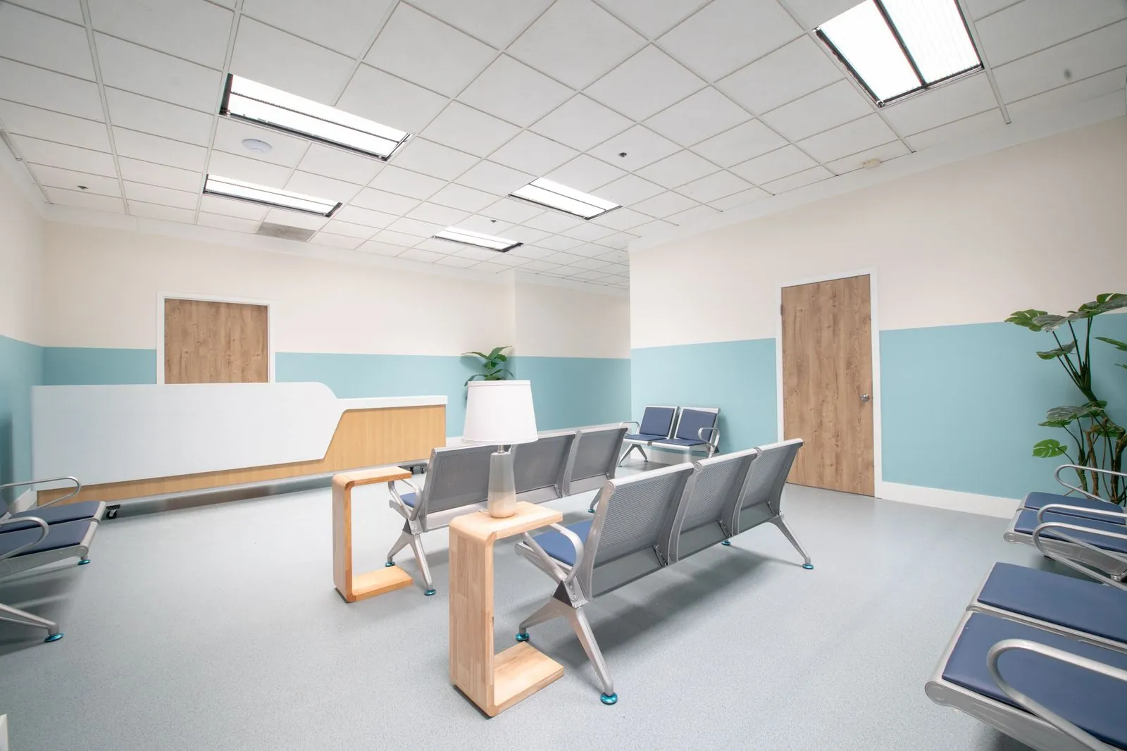 Hospital waiting area with gang seating and reception desk
