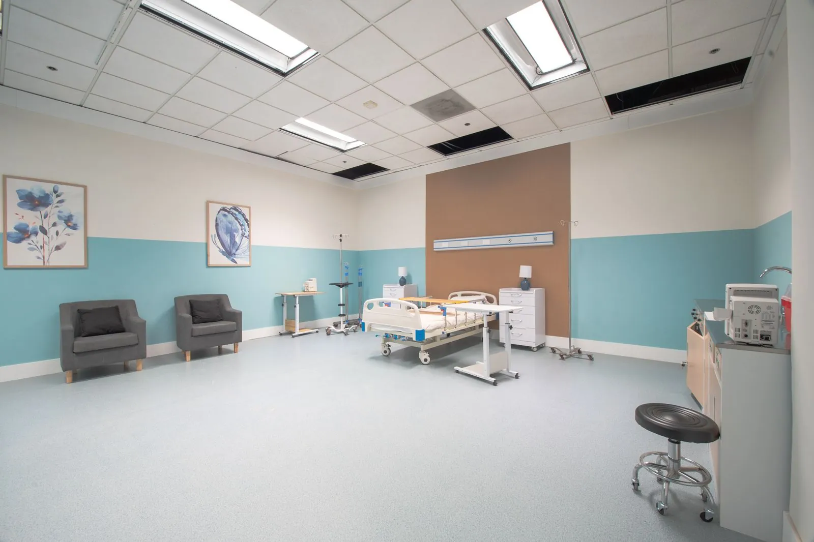 Patient room with armchairs and bedside equipment