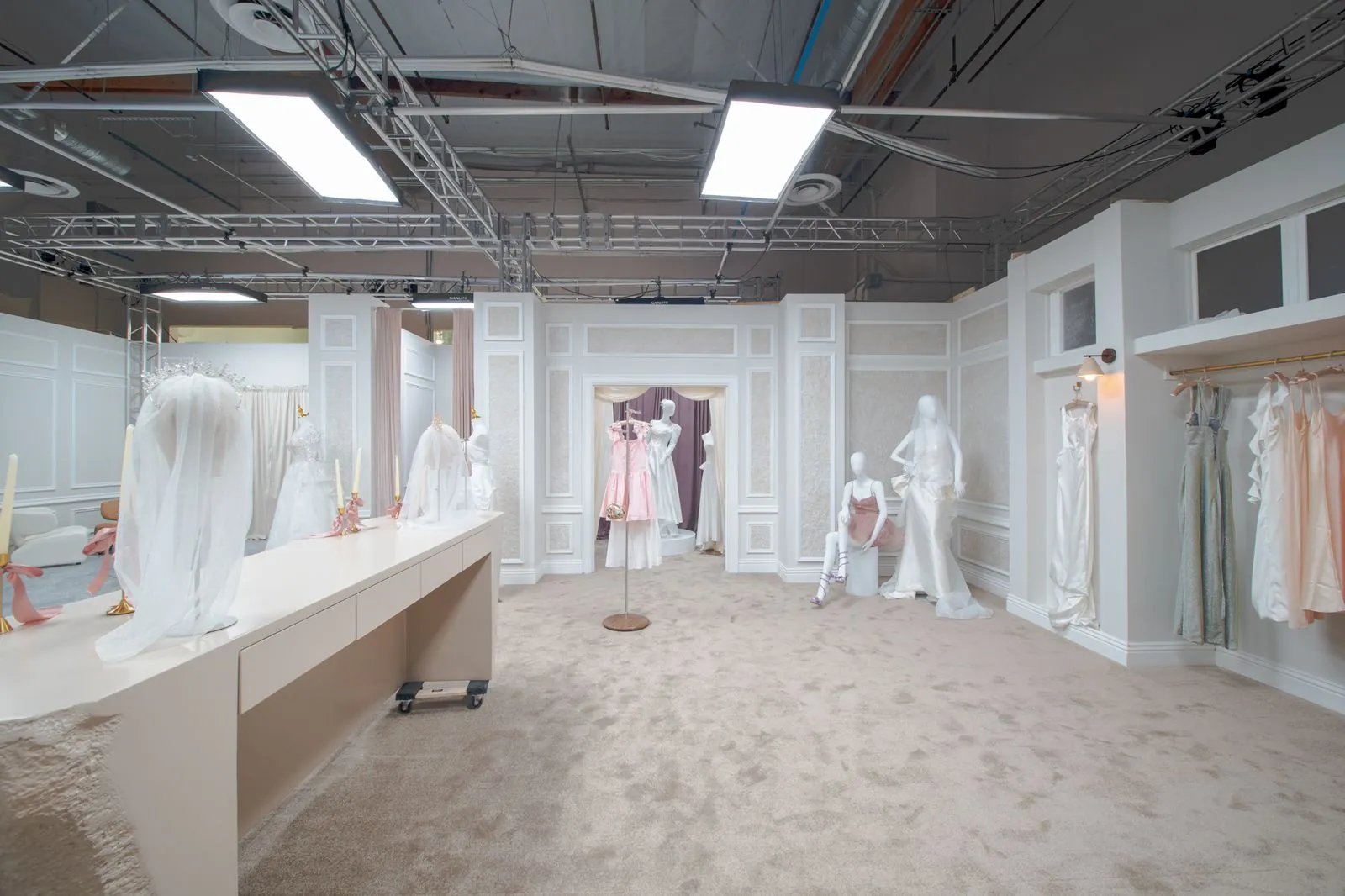 Bridal shop counter with gowns on the far wall