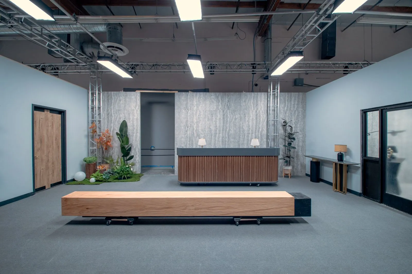The reception desk and travertine feature wall in the corporate office set's lobby