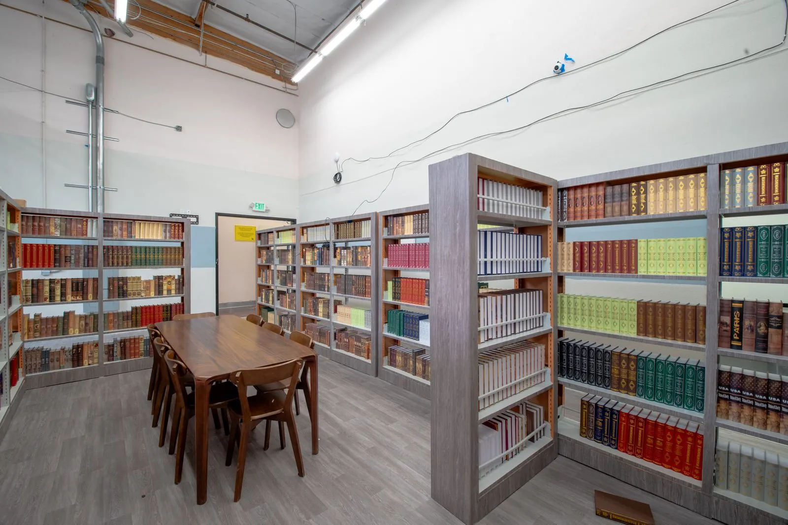 Library reading table surrounded by book stacks