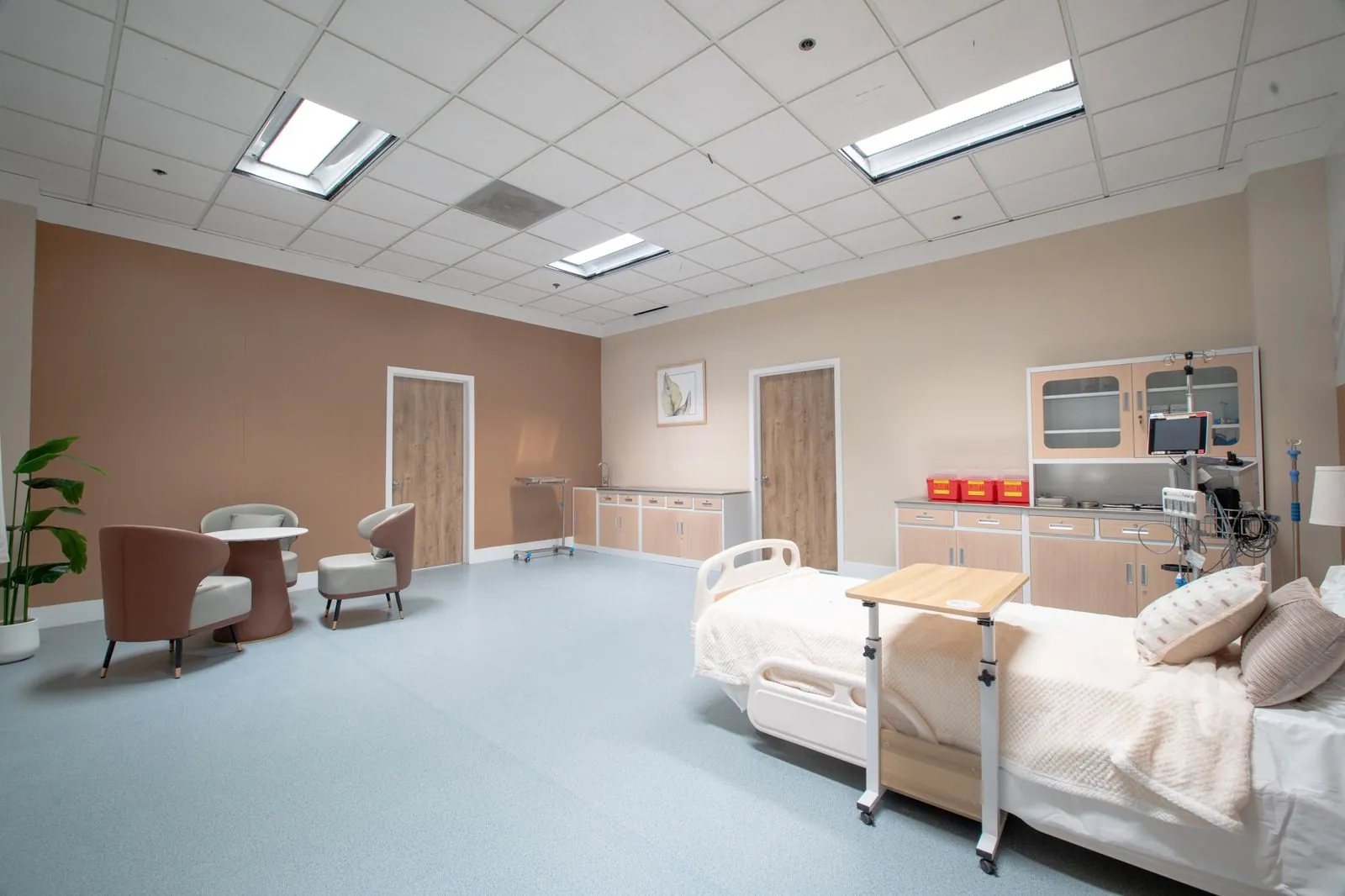Patient room with bed, monitors and a seating area