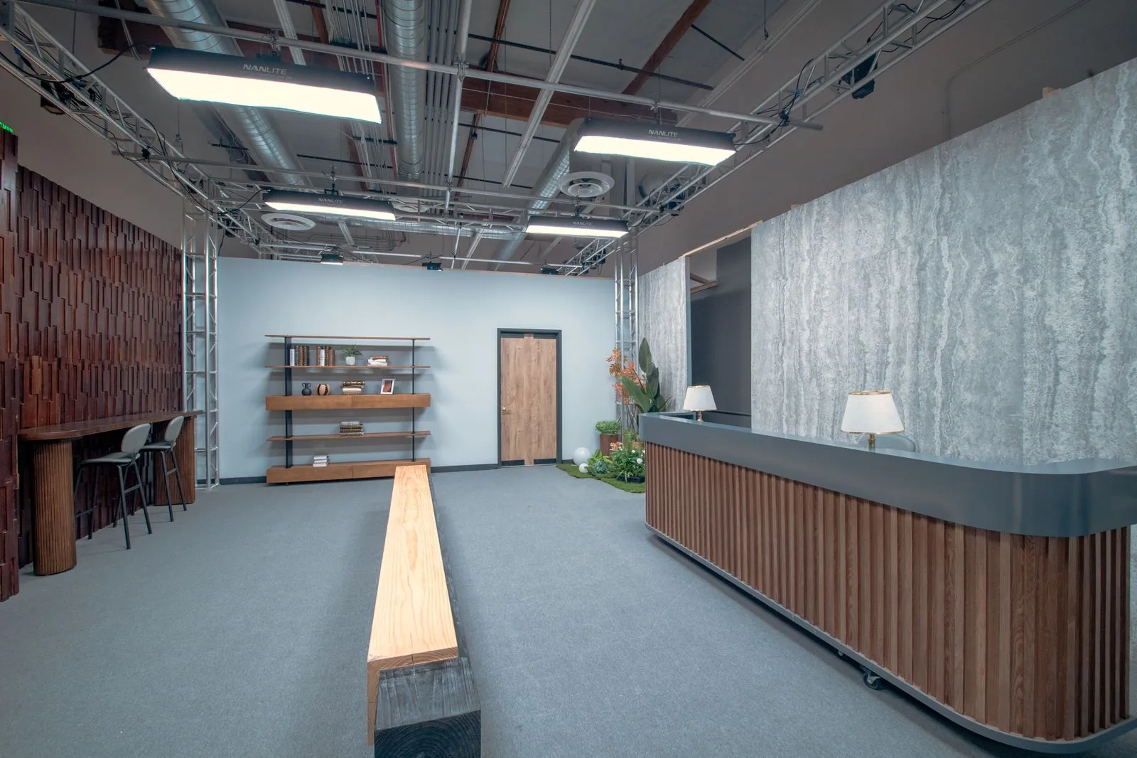 Office lobby looking past the dark wood feature wall toward reception