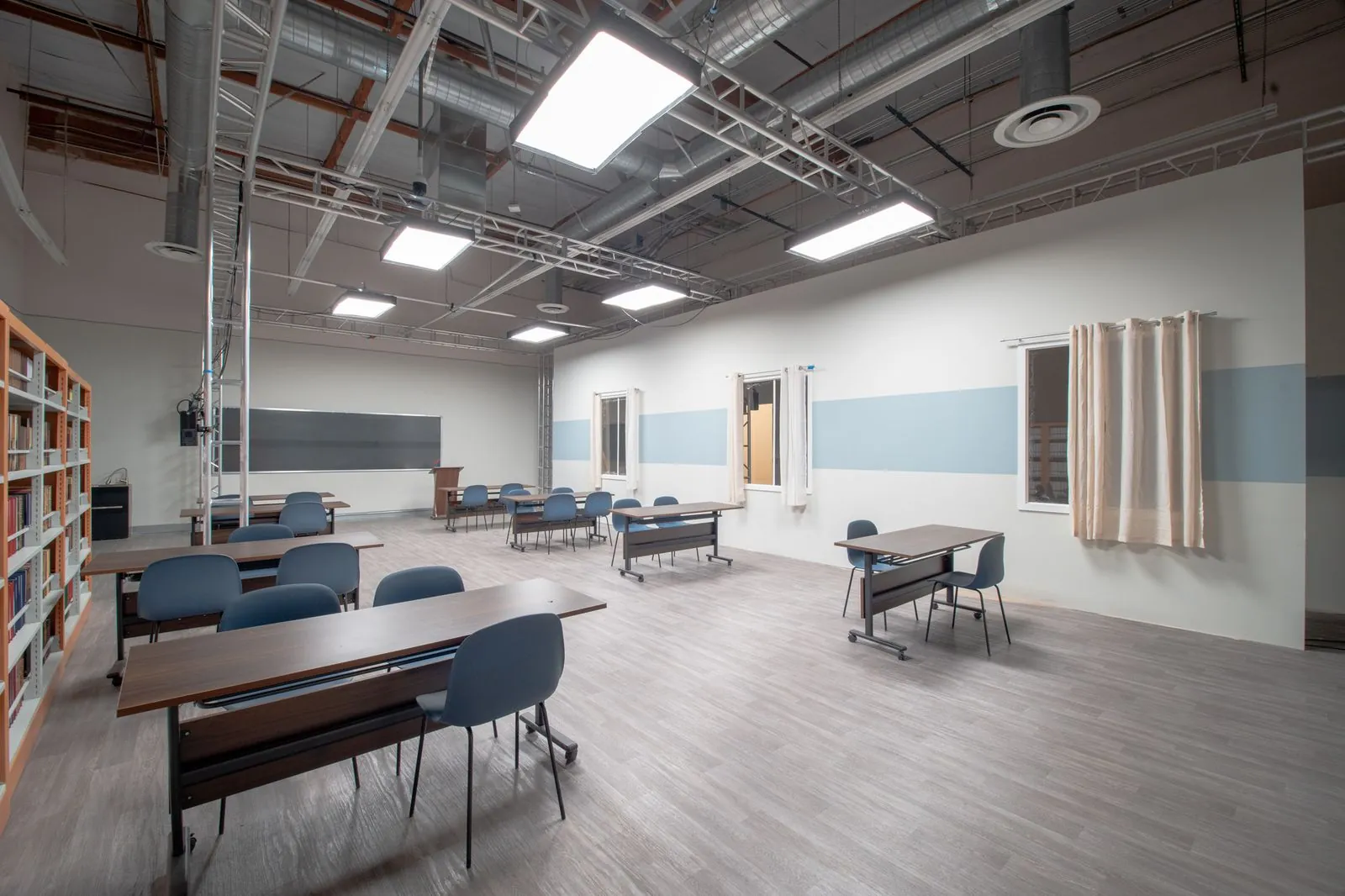 School classroom with chalkboard, lectern and rolling desks