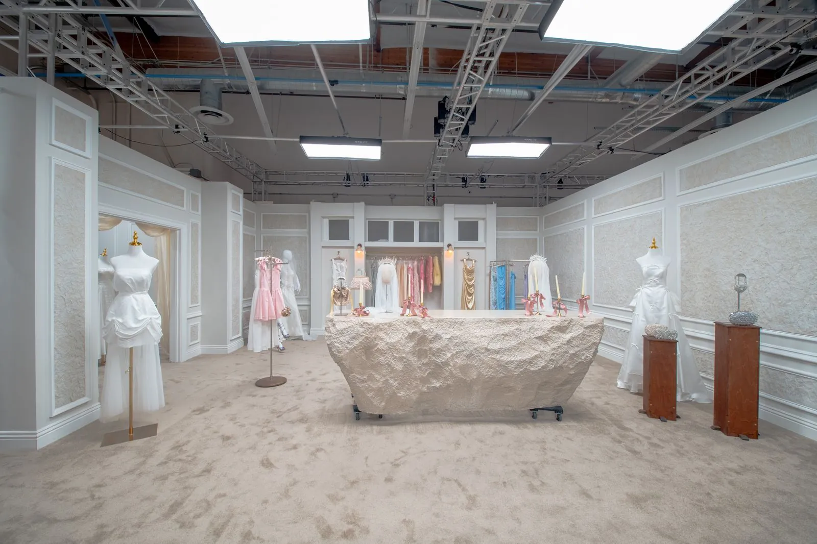 Bridal boutique with gowns, mannequins and a central display table