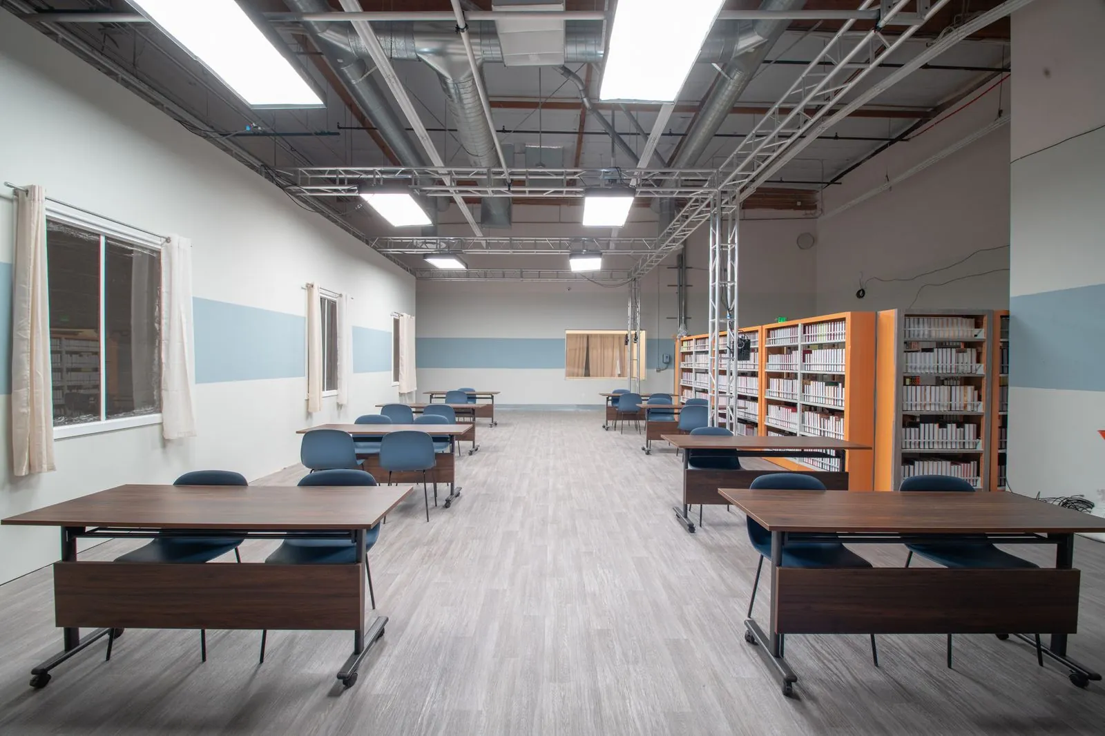 Classroom seating and shelving along the window side