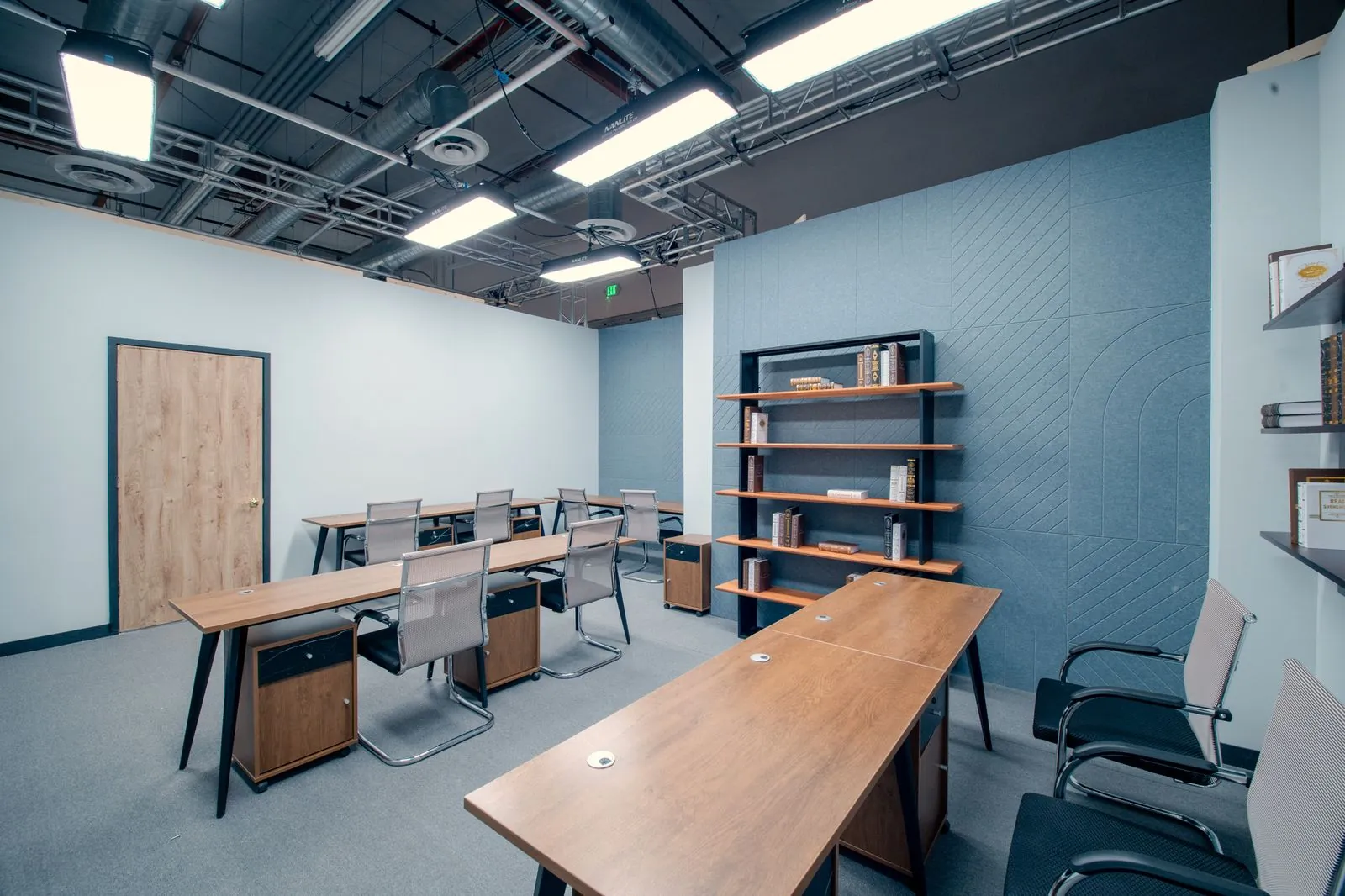 Desks and shelving in the open bullpen of the corporate office set